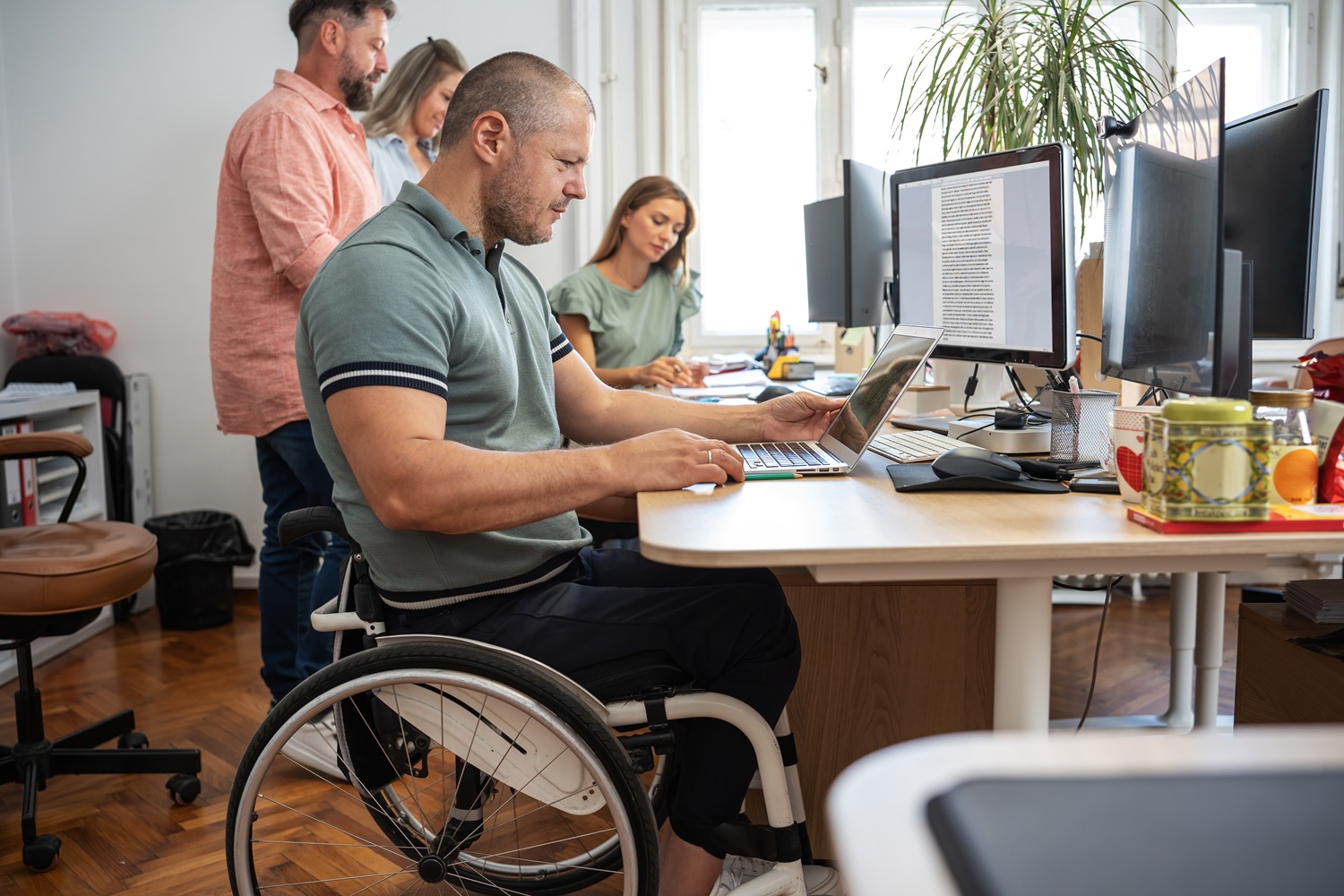 mężczyzna na wózku pracuje przy komputerze